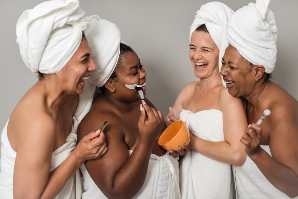 multiracial girlfriends laughing during skin care